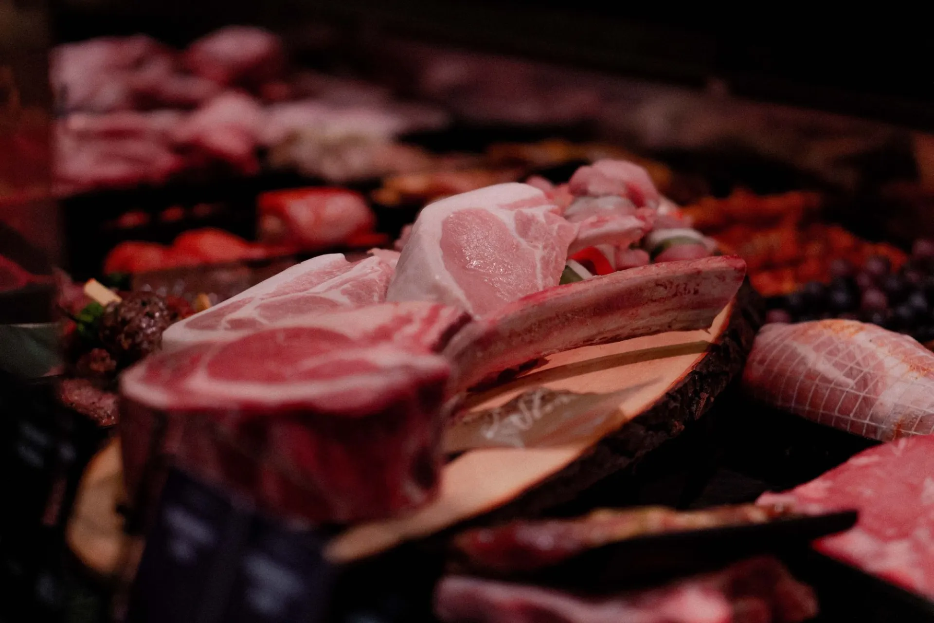 Raw cuts of meat laid out on a butcher's counter